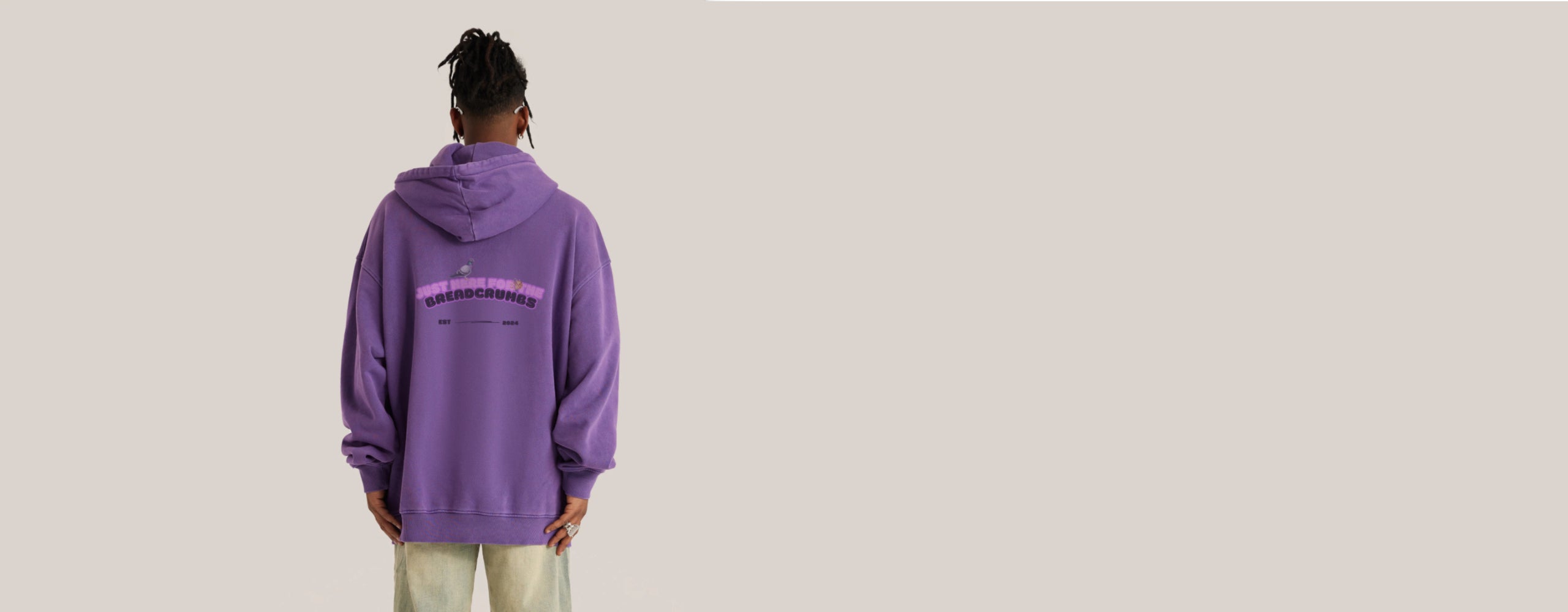 Title image of a retro hoodie featuring the back view on a model, highlighting the oversized fit and vintage-inspired design with unique detailing.